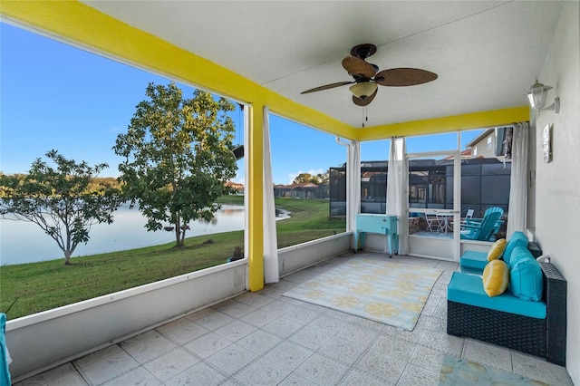 unfurnished sunroom with a water view and ceiling fan