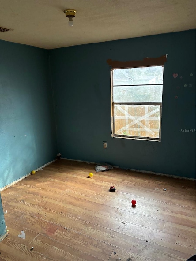 unfurnished room with light hardwood / wood-style flooring