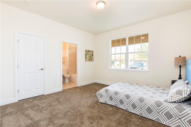 carpeted bedroom featuring connected bathroom