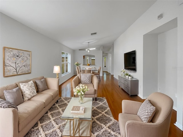 living room featuring hardwood / wood-style flooring, ceiling fan, and lofted ceiling