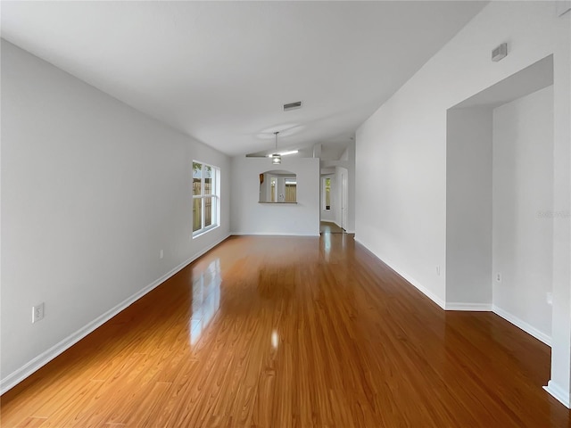 unfurnished living room with hardwood / wood-style floors, ceiling fan, and lofted ceiling