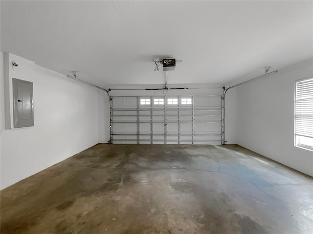 garage with a garage door opener and electric panel