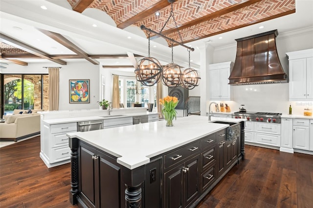 kitchen with brick ceiling, a large island, stainless steel appliances, and custom range hood