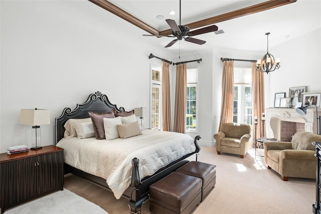 bedroom featuring ceiling fan with notable chandelier, light colored carpet, and ornamental molding