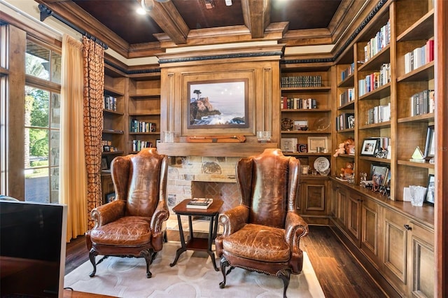 living area featuring beamed ceiling, wood-type flooring, and crown molding