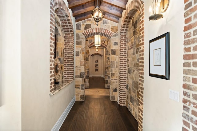 corridor featuring vaulted ceiling with beams and dark hardwood / wood-style flooring