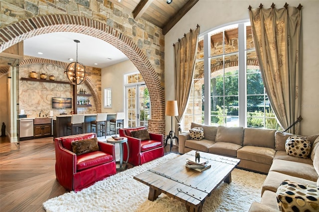 living room with parquet floors, wood ceiling, beam ceiling, high vaulted ceiling, and an inviting chandelier