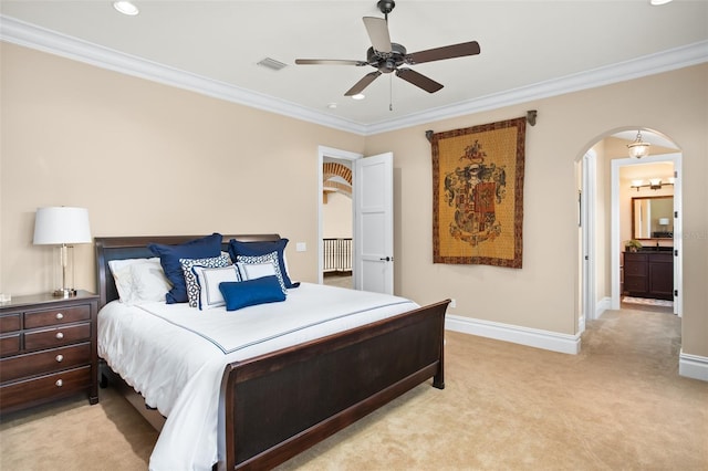 bedroom with light colored carpet, ensuite bath, ceiling fan, and ornamental molding