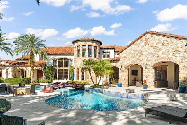 view of swimming pool with a patio and pool water feature