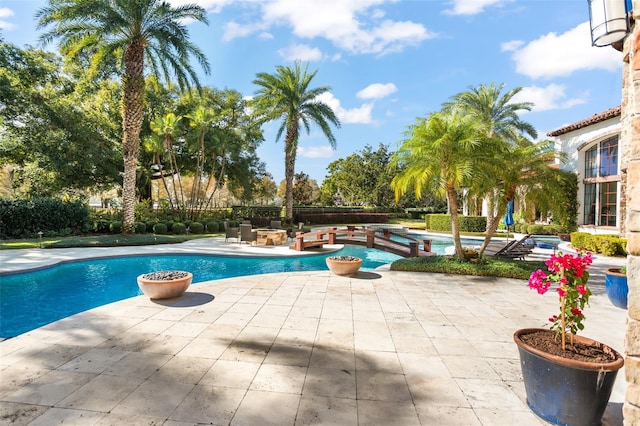 view of pool with a jacuzzi and a patio