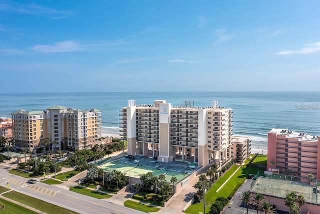 drone / aerial view with a water view and a beach view