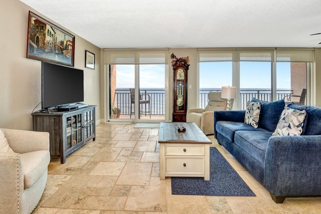 living room featuring expansive windows and a textured ceiling