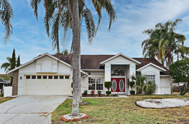 view of front of property with a garage and a front lawn