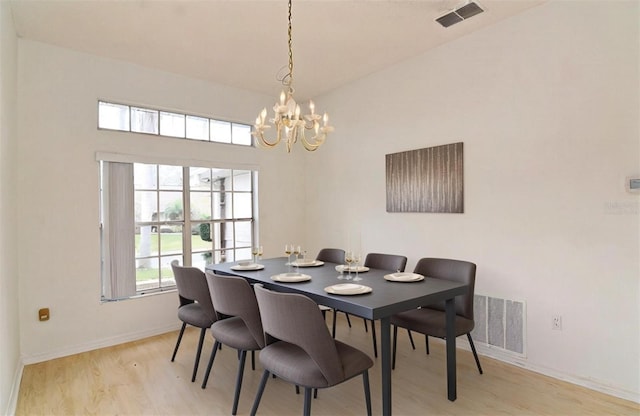 dining space with a chandelier and light hardwood / wood-style floors