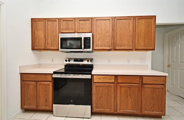 kitchen with appliances with stainless steel finishes and light tile patterned floors