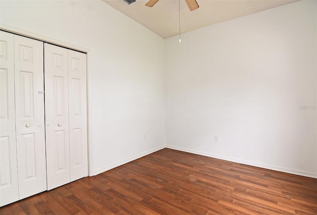 unfurnished bedroom featuring ceiling fan, a closet, and dark hardwood / wood-style floors