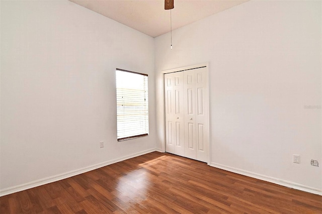 unfurnished bedroom with hardwood / wood-style floors, a closet, and ceiling fan