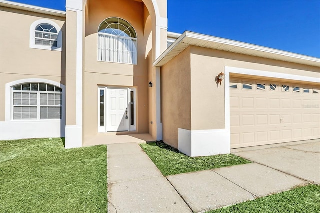 view of exterior entry with a garage