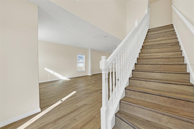 stairway with hardwood / wood-style flooring