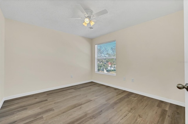 unfurnished room featuring a textured ceiling, hardwood / wood-style flooring, and ceiling fan