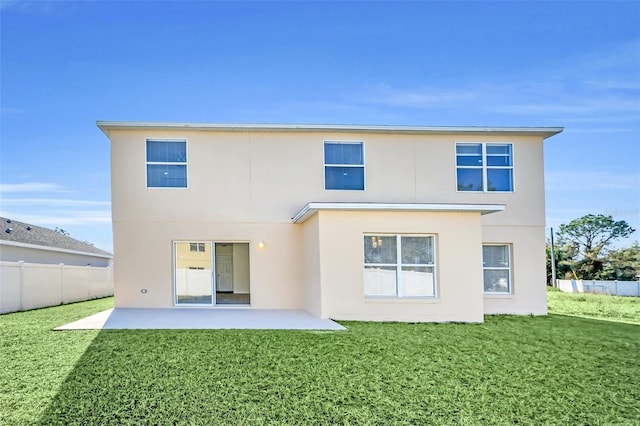 back of property featuring a patio area and a yard