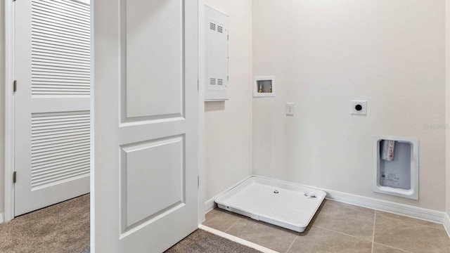 clothes washing area featuring hookup for an electric dryer, hookup for a washing machine, and light tile patterned floors