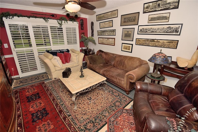 living room with ceiling fan and ornamental molding