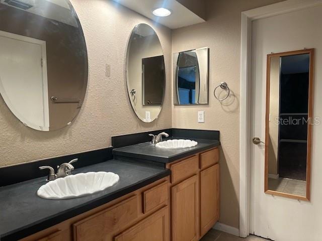 bathroom featuring tile patterned flooring and vanity