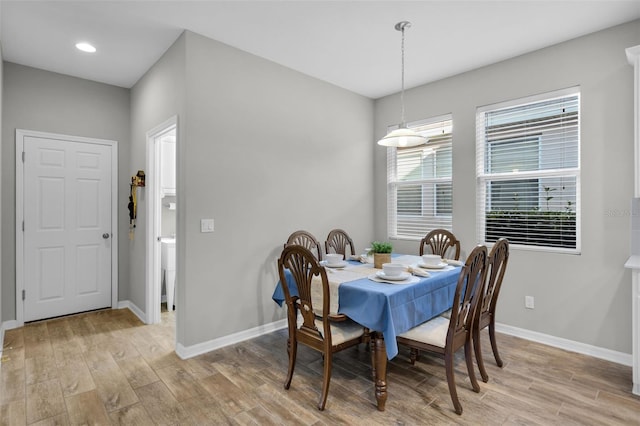 dining space with light hardwood / wood-style flooring