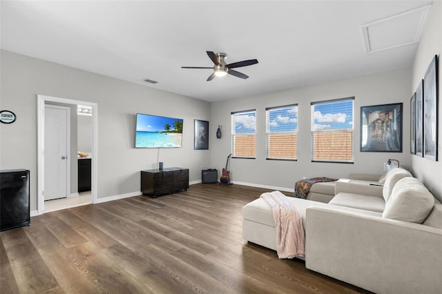 living room featuring ceiling fan and hardwood / wood-style flooring