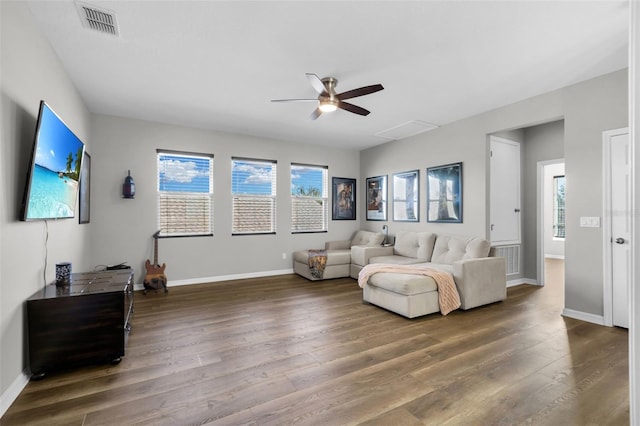 living room with ceiling fan and dark hardwood / wood-style flooring