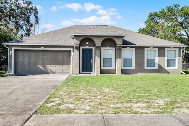 single story home with a garage and a front lawn