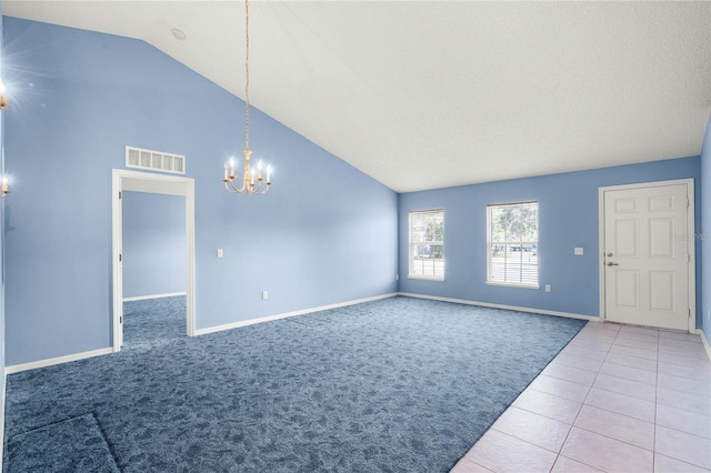 interior space featuring tile patterned flooring, a chandelier, and lofted ceiling