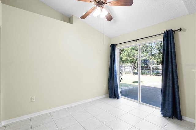 empty room featuring light tile patterned floors, ceiling fan, and lofted ceiling