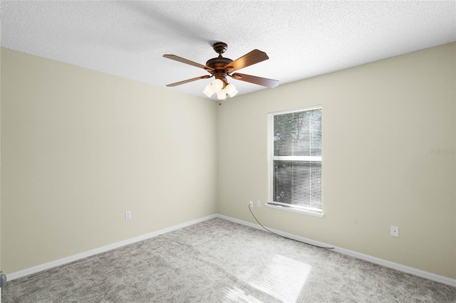 spare room with carpet, a textured ceiling, and ceiling fan