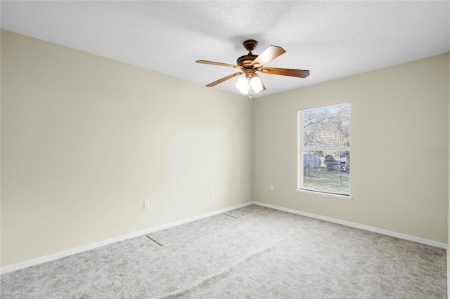 unfurnished room featuring carpet flooring, a textured ceiling, and ceiling fan