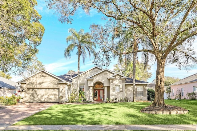 view of front of home with a garage and a front lawn