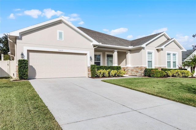 view of front of home with a front yard and a garage