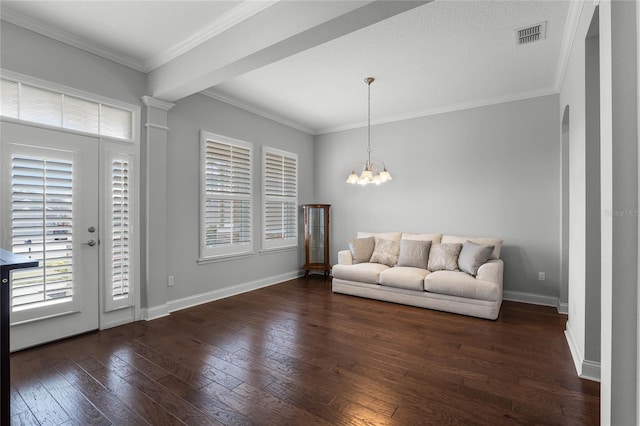 entryway featuring dark hardwood / wood-style flooring, crown molding, and an inviting chandelier