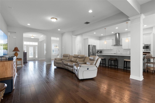 living room with dark hardwood / wood-style flooring and sink