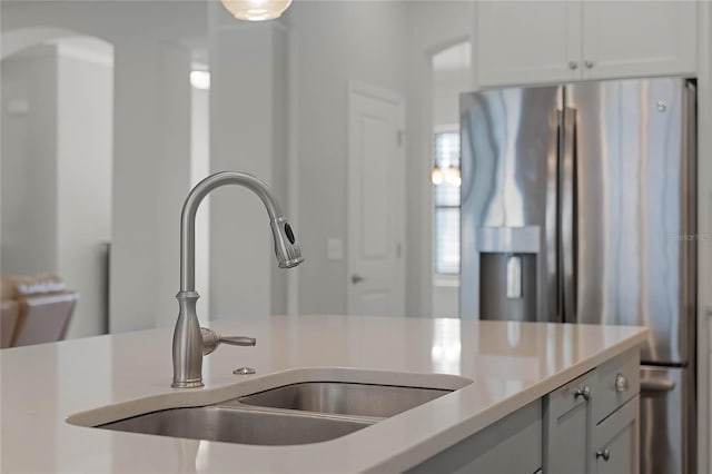 kitchen featuring stainless steel fridge and sink