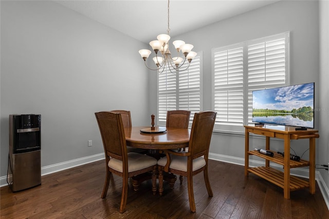 dining space with dark wood-type flooring and a notable chandelier