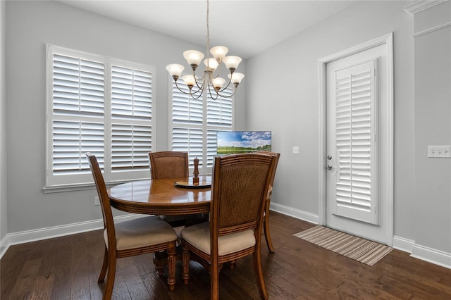 dining room featuring a notable chandelier, dark hardwood / wood-style flooring, and a wealth of natural light