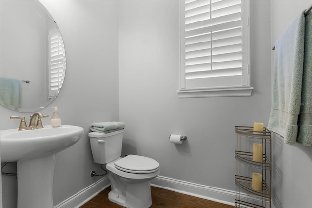 bathroom with sink, hardwood / wood-style floors, and toilet