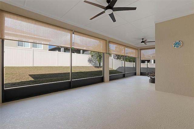 unfurnished sunroom with ceiling fan