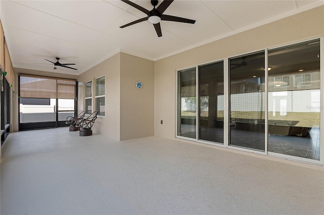 unfurnished sunroom with ceiling fan