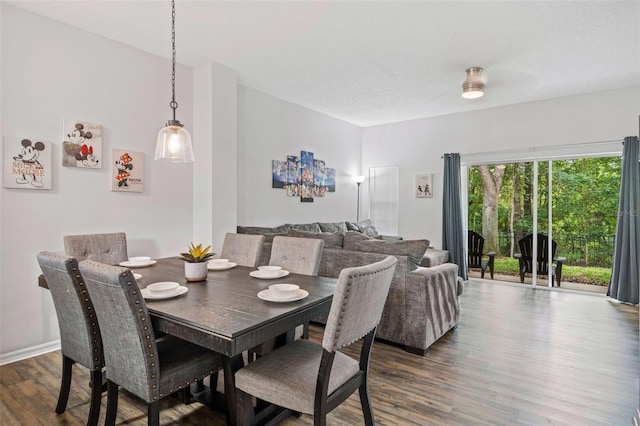 dining space featuring dark hardwood / wood-style flooring and a textured ceiling