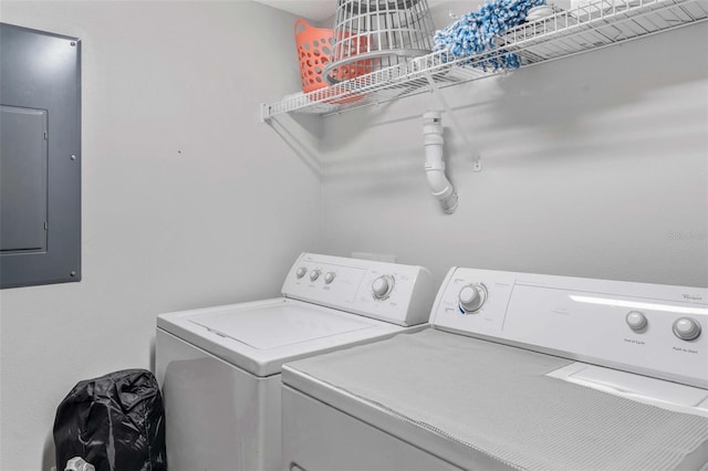 laundry area featuring electric panel and separate washer and dryer