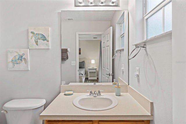 bathroom featuring vanity and toilet