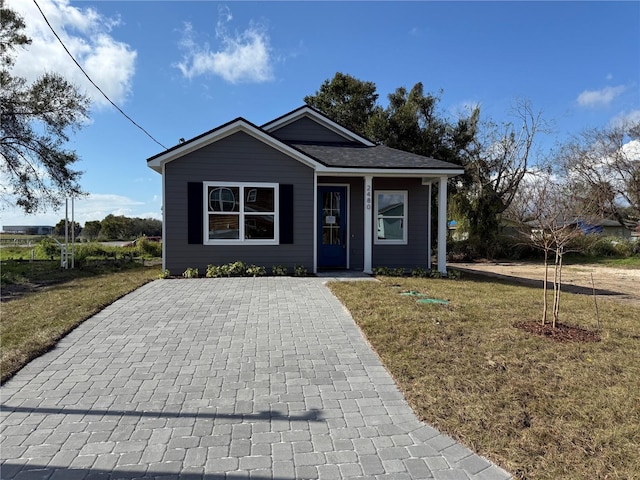 bungalow-style home featuring a front lawn